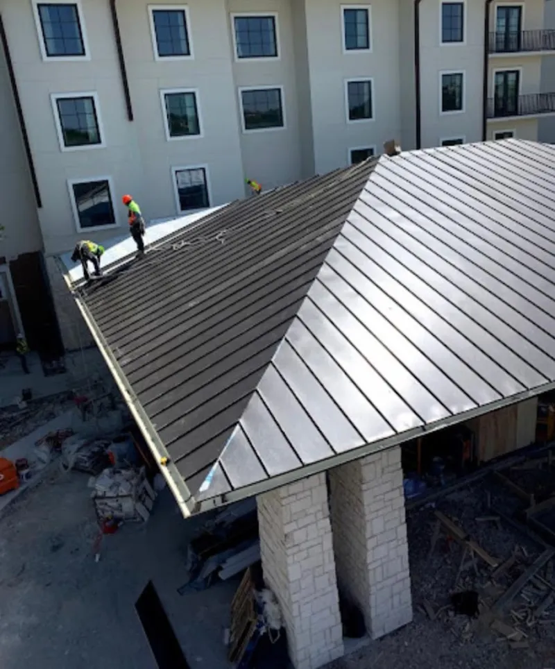 Crew installing standing seam metal roof panels on a commercial project in Sierra Vista Southeast